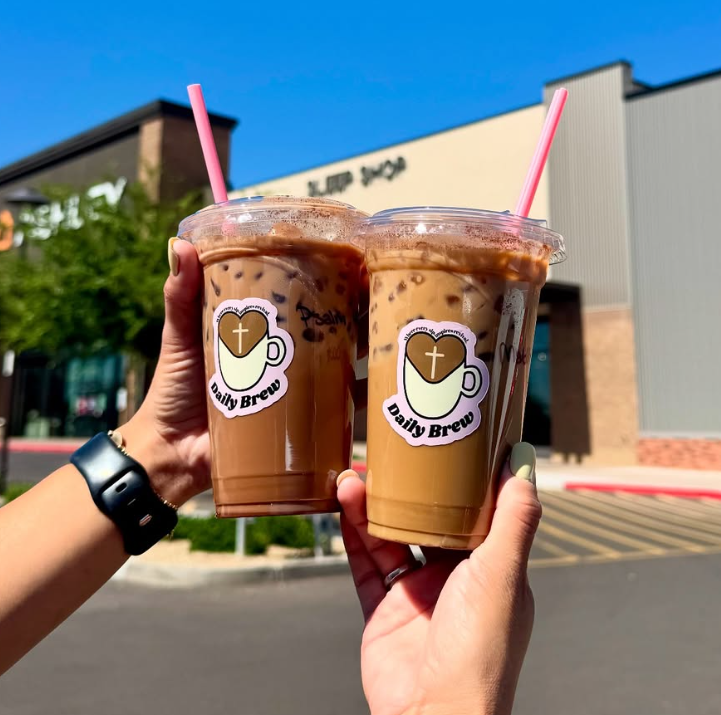 Custom Daily Brew logo stickers on two iced coffee cups