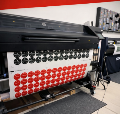 Sheets of round custom stickers being printed at Coyote Color